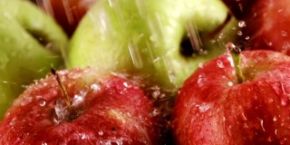 把绿色的健康苹果放在桌上，用水滴洗净