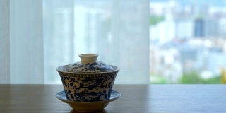 中国茶杯放在窗户旁边的桌子上