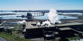 工业是否意味着污染?该工厂位于明尼苏达州五大湖之一的苏必利尔湖岸边。无人机视频与全景相机运动。