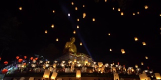 在泰国北部的兰汶，水灯节上，漂浮的灯笼被抛向大佛上空