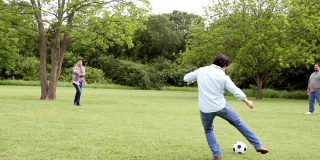男性家庭成员在家庭聚会上踢足球