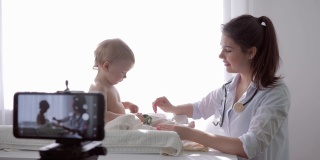 视频博客，博客女医生在为关注者录制儿童体检期间的手机直播教程视频