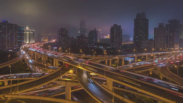 白天到夜晚的空中运动高架公路交汇处x形道路日落时的鸟瞰图时间流逝。交通运输概念在城市城市，上海市中心，中国在4k视频