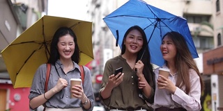 三个迷人的女性朋友享受在雨天散步