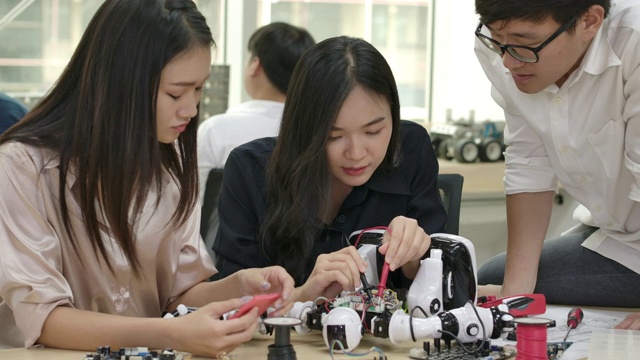 电子工程师团队与机器人一起工作，在车间建造，修理机器人。有技术或创新观念的人。