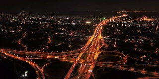 在高速公路路口行驶的汽车鸟瞰图的时间流逝。桥梁道路形状的数字8或无限符号联系建筑的概念。前视图。城市城市，台北晚上，台湾。