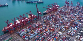 集装箱货轮在进出口业务和物流国际货物中的航拍折叠。由起重机在香港维多利亚港的晚上运往港口。