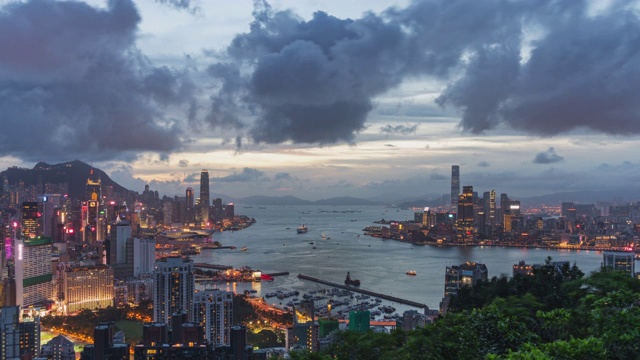 从红香炉山顶，4K DCI白天到晚上的时间拍摄香港岛、维多利亚港和九龙城的景观或城市景观。亚洲旅游目的地概念。缩小的效果