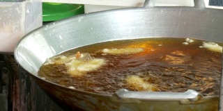 泰式香蕉油煎，厨师将香蕉放入油煎锅中。