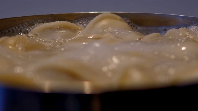 大黄饺子在汩汩的水里煮，带着泡沫
