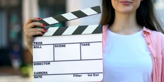 手持拍板的年轻女子，电影助理导演，视频制作