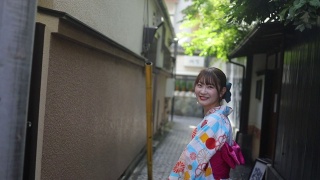 年轻女子在浴方走传统的日本狭窄的小路视频素材模板下载
