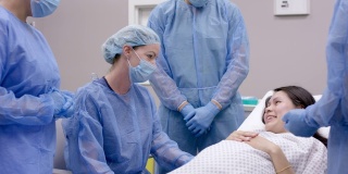 一名白人医生和她的手术团队为孕妇做手术