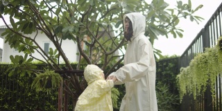 和年轻女人在雨中玩耍的孩子们