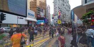 一群人走在斑马线或人行横道上的时间流逝，在香港市区铜锣湾区购物区和百货商店。