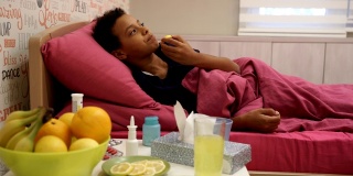 小黑人女孩吃柠檬。流感季节到了。