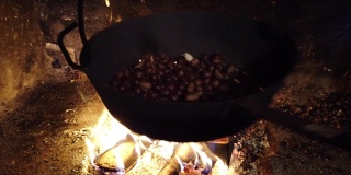 秋天的一天，用平底锅在火上烤栗子