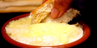 浸在预热的圣费利西安奶酪中的法棍面包
