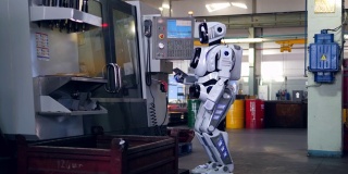 在工厂，一个机器人一边检查机器，一边用平板电脑工作。