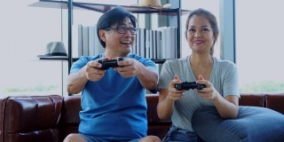 Old man and woman playing video game