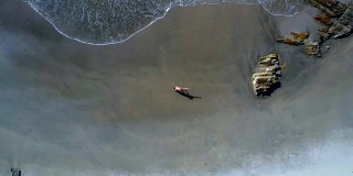 空中平滑波浪卷在海滩上瑜伽姿势的女孩Figure