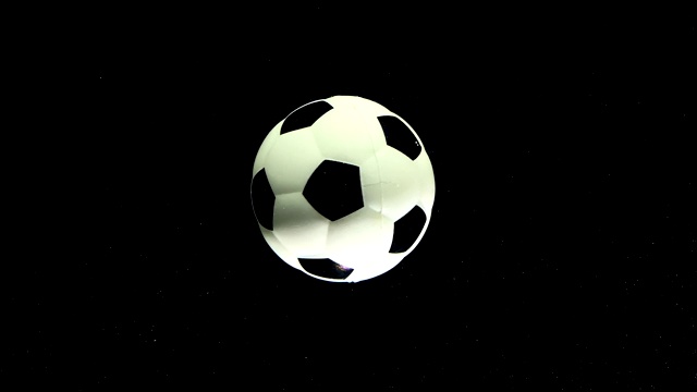 足球在一个黑色的太空星背景上绕着它的轴旋转。