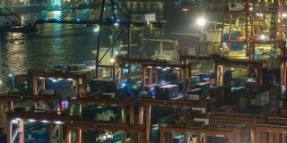 4K延时:码头商埠的集装箱货物仓库和工作吊车桥在夜间装卸集装箱，用于商业物流、进出口、运输。