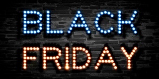 黑色星期五灯泡字动画在黑色砖的背景