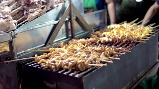 泰国街头小吃烤鱿鱼串。视频素材模板下载
