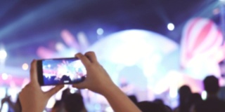 音乐爱好者用手机录制音乐会的场景，假期周末的概念，人们的生活方式