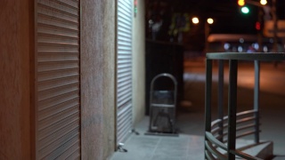 空夜城市街道，卷帘在紧闭的店铺门口。视频素材模板下载