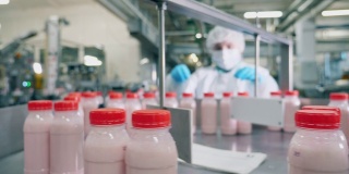 一个在工厂里处理酸奶瓶的人。