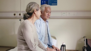 老年亚洲妇女在病房安慰丈夫视频素材模板下载