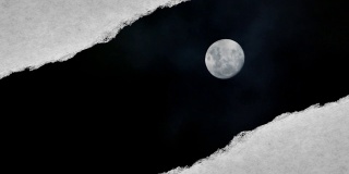 这段创造性的视频拍摄了夜空中一轮明亮的满月和漂浮的云，通过一个边缘撕裂的洞可以看到，这个洞是用复古的旧纸张做的。