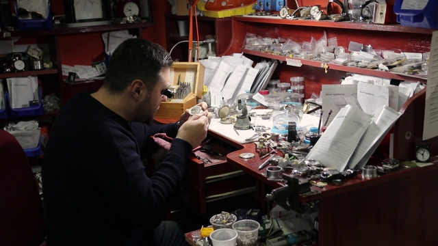 Watchmaker repairing a vintage pocket watch