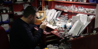 Watchmaker repairing a vintage pocket watch
