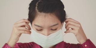 带卫生口罩的亚洲妇女