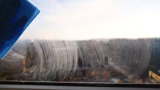 员工手戴橡胶防护手套，用微纤维布擦拭窗户上的灰尘。,大扫除视频素材模板下载