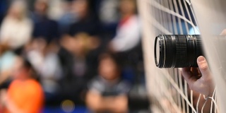 在一场体育比赛的摄影报道中，透过安全网可以看到摄影师的镜头
