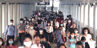 慢镜头场景:早高峰时间，亚洲人在曼谷上班时戴着预防冠状病毒或新冠病毒的面罩和空气中的微尘pm 2.5