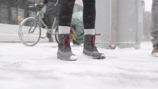 近距离拍摄下雪时的两双脚视频素材模板下载