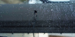 一辆汽车沿着冲洗隧道行驶的内景。洗车时从车内清洗，湿后的挡风玻璃全部洗车
