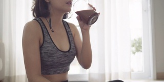 在家锻炼后喝蛋白质奶昔的健康女性