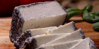 特写的软山羊奶酪与灰色的霉菌切三角形块