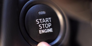 手指按发动机启动按钮，按下启动汽车