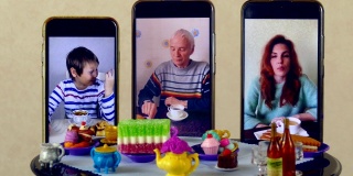 家庭通过视频连接在娃娃桌上交流和喝茶