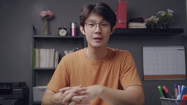 4k分辨率漂亮的亚洲男老师在视频会议上向他的在线学生解释数学作业。他利用在线视频通话技术在冠状病毒封锁期间在家教授数学公式。远程办公和在线学习。