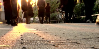人们走在光晕击中镜头。低角度拍摄行走在城市生活中的人们