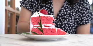 女人在咖啡馆吃草莓蛋糕的特写。