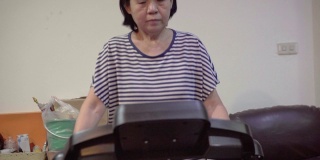 Senior Asian woman ran a home exercise during the Covid-19 virus.